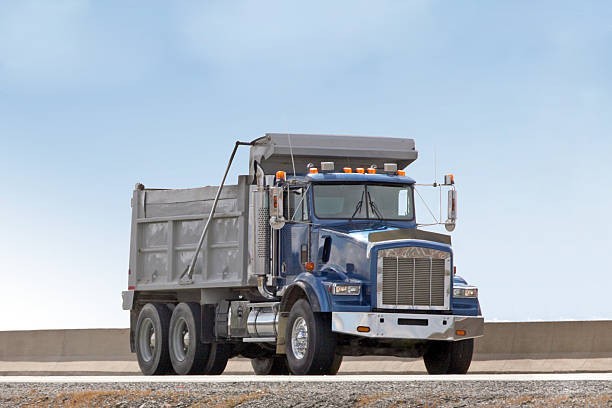 istock Front Quarter View Of A Dump Truck Travelling On Highway 473359050