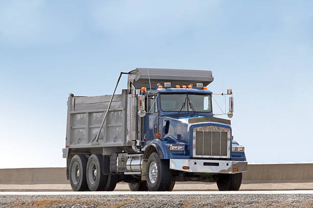 Front Quarter View Of A Dump Truck Travelling On Highway stock photo