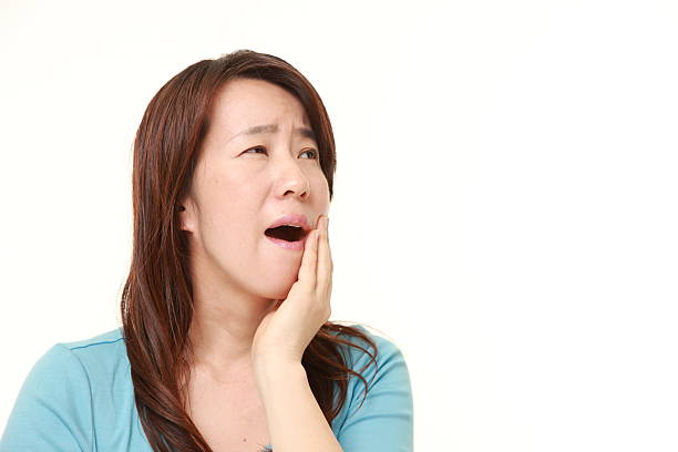 istock Japanese woman suffers from toothache 473367872