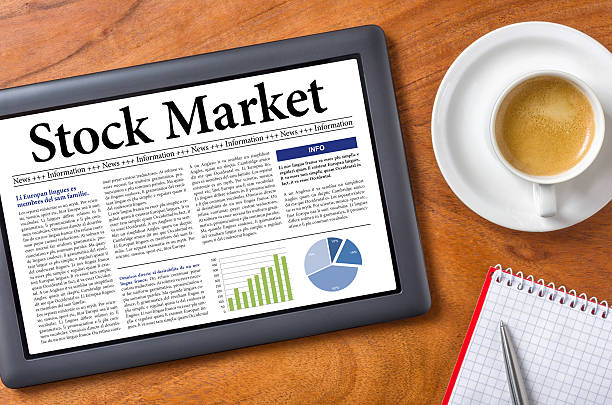 istock Tablet on a desk - Stock Market 473373180
