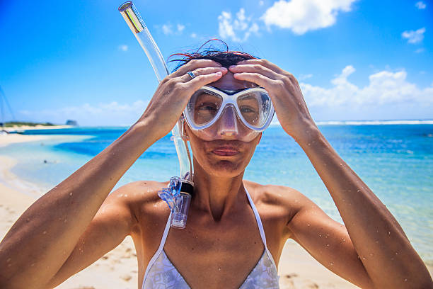 istock Happy woman getting ready for snorkeling 473373514