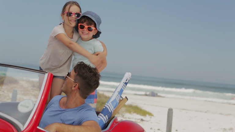 Father and children in convertible