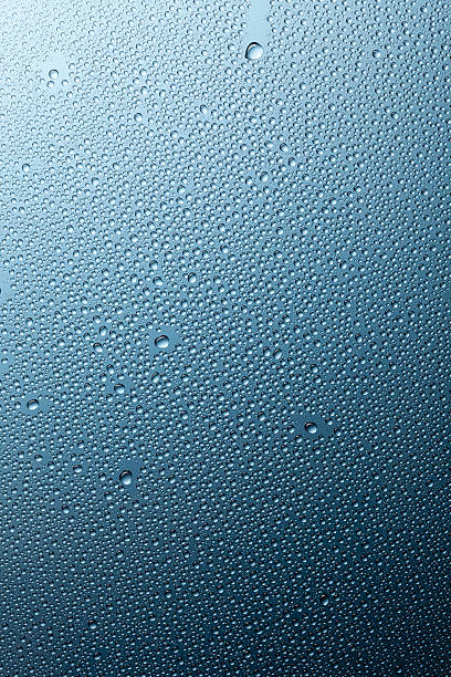 istock Water droplets on glass - Raindrops Rain Window Blue Macro 473374278