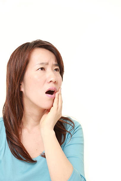 istock Japanese woman suffers from toothache 473374714