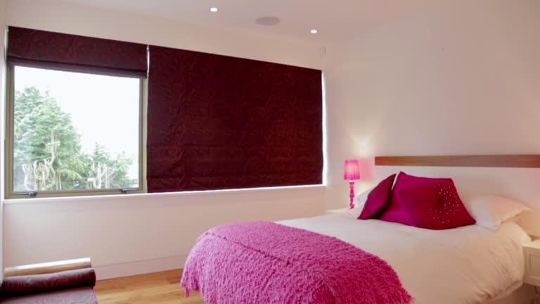 Pink blanket and pillows on bed