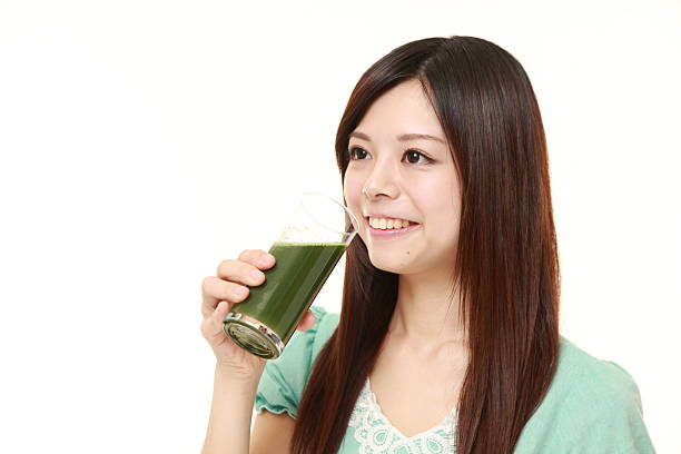 istock woman with green vegetable juice 473376462