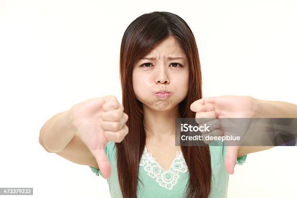 Woman With Thumbs Down Gesture Stock Photo - Download Image Now - 2015, Adult, Adults Only