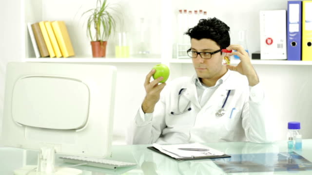 Young Doctor Choosing Pills Over Fruit Medicine Concept