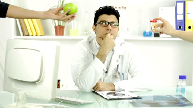 Young Doctor Thinking Healthy Apple or Pills Offering Fruit