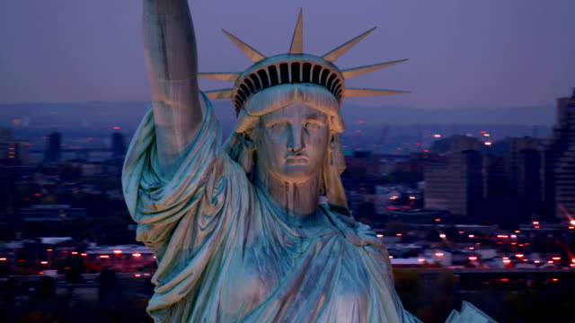 Closeup aerial shot, Statue of Liberty at dusk