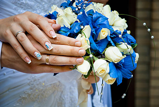 Bride and groom's hands with wedding rings. Soft focus