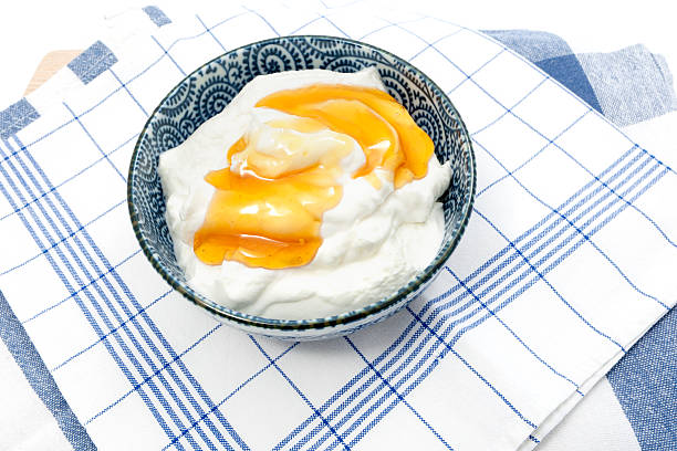 Greek yogurt with honey in a pot stock photo