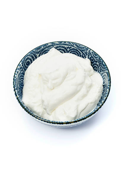 Tart Greek yogurt in a small blue bowl stock photo