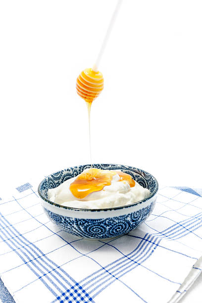 istock Greek yogurt with honey in a pot 473417406