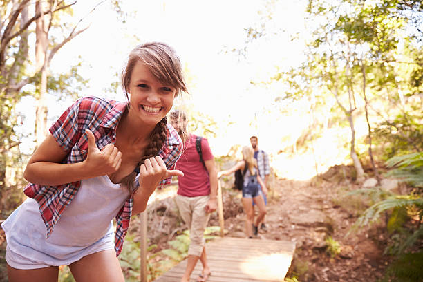 istock Woman On Walk With Friends Making Funny Gesture At Camera 473420136