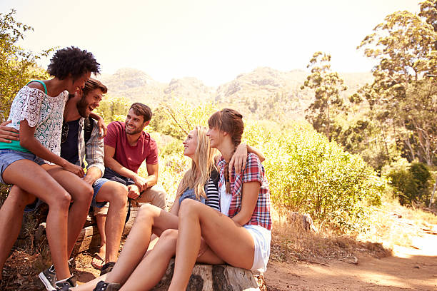 istock Group Of Friends Resting On Walk Through Countryside 473421038