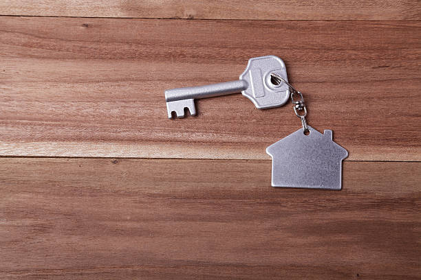 istock Silver house and key chain on a wood table 473421632