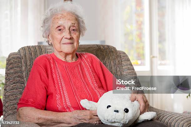 Senior Woman Sitting In Armchair Stock Photo - Download Image Now - 2015, 80-89 Years, Adult