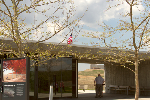 Somerset County, PA, USA - May 8, 2015 : Visitors entering Flight 93 National Memorial through archway showing new visitors center under construcion in distance.
