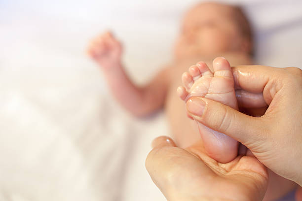 istock Mother makes massage for happy baby 473423204