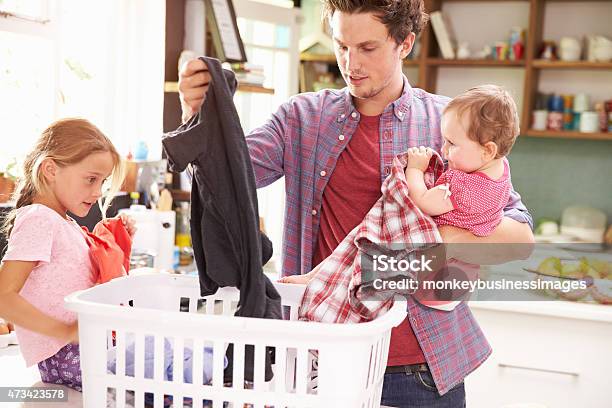 Father And Children Sorting Laundry In Kitchen Stock Photo - Download Image Now - Laundry, Stay-at-Home Father, Father