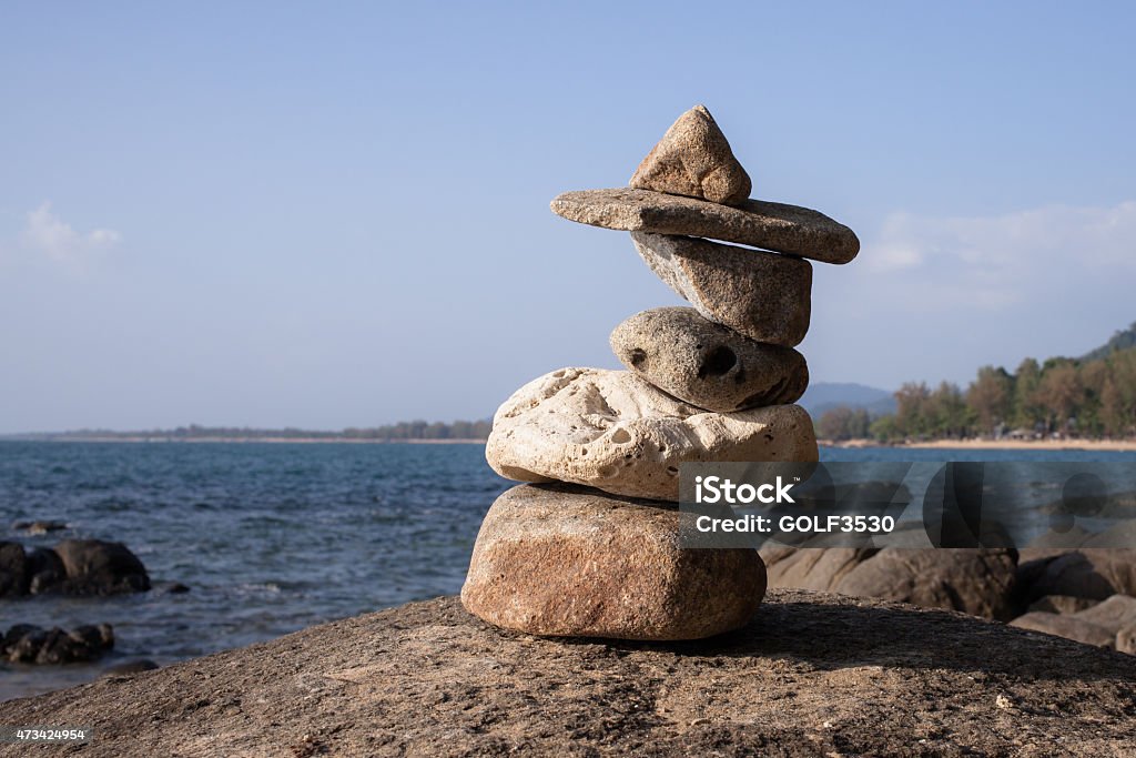 Stack of pebbles on a big rock at the beach. 2015 Stock Photo