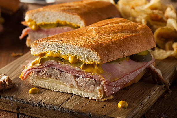 Homemade Traditional Cuban Sandwiches Homemade Traditional Cuban Sandwiches with Ham Pork and Cheese cuban culture photos stock pictures, royalty-free photos & images