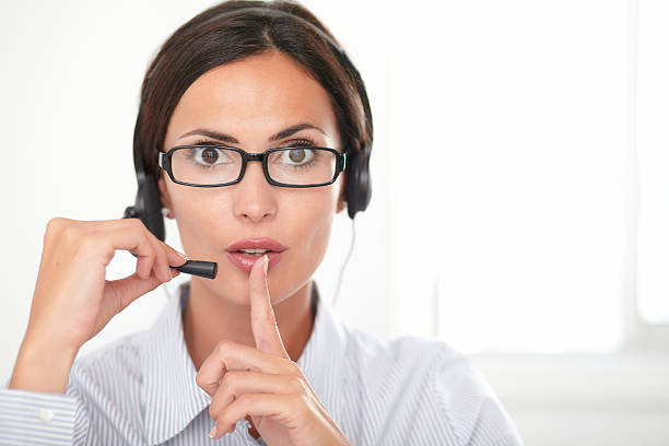 istock Pretty employee speaking on the headset 473427336