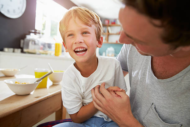istock Father and sitting eating breakfast together 473428268