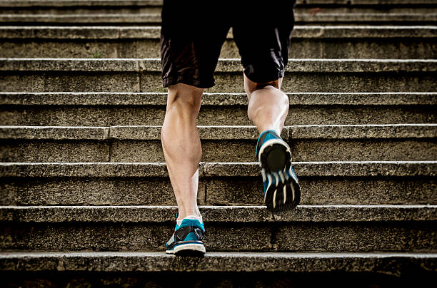 istock athletic sport runner man running up stairs in urban training 473432708