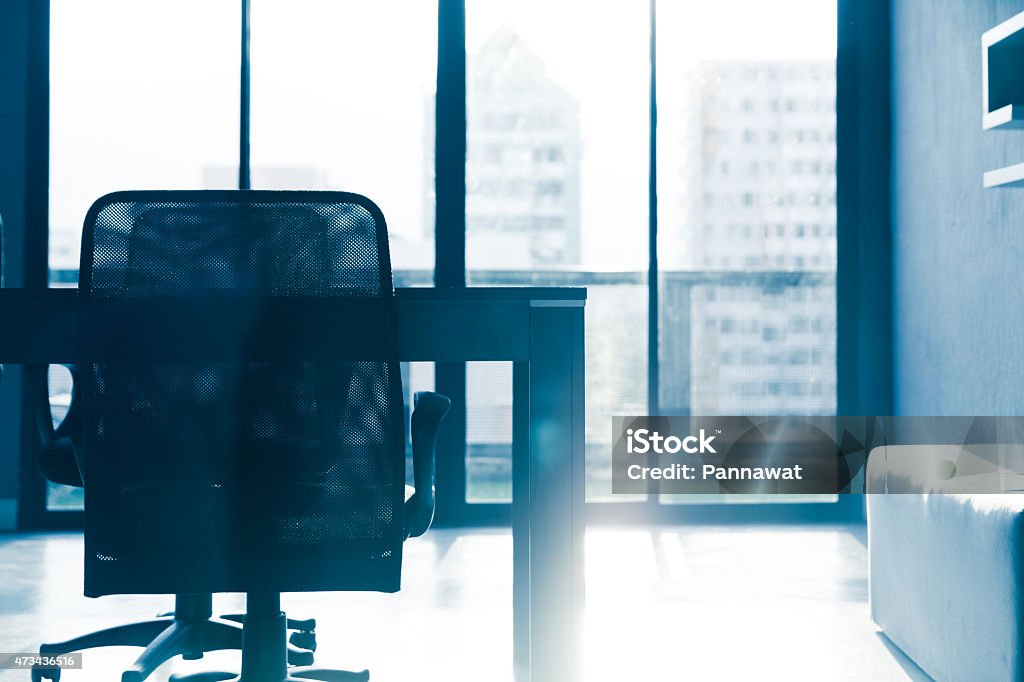 Blue tone silhouette of empty conference table and chairs blue tone of  conference table and chairs with sun light in meeting room ,business  room Empty Desk Stock Photo