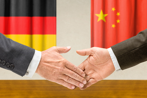 Representatives of Germany and China shake hands