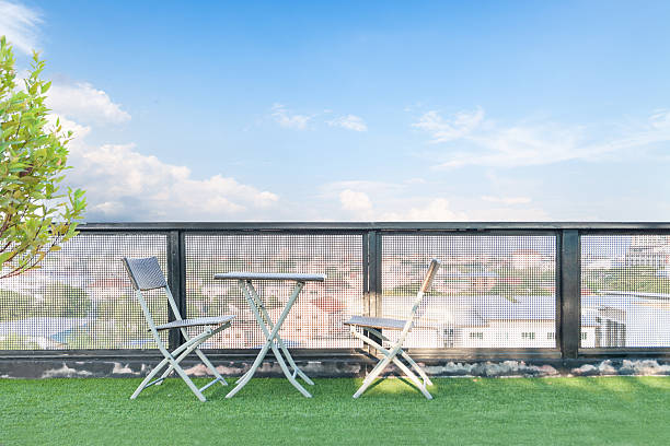 wicker chair  and a table on an open terrace with blue sky