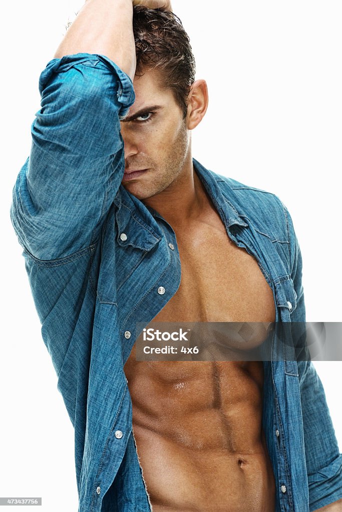 Muscular man looking at camera Muscular man looking at camerahttp://www.twodozendesign.info/i/1.png 20-29 Years Stock Photo