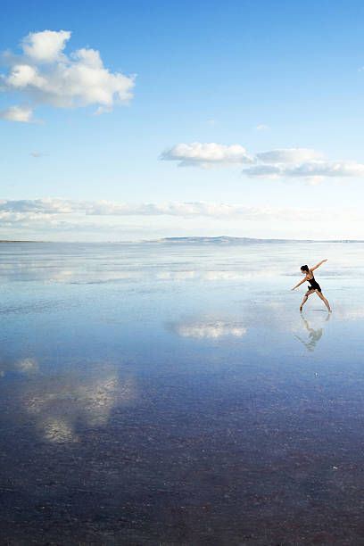 istock Beautiful modern ballet dancer dancing on the lake with tulle 473437840