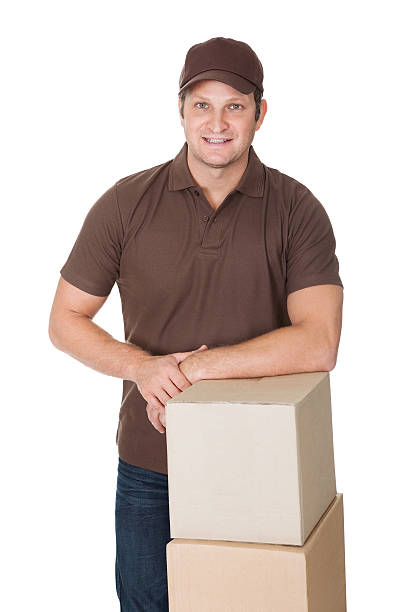 istock Portrait of delivery man with stack of boxes 473438998