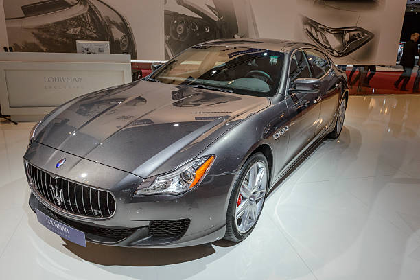 Amsterdam, The Netherlands - April 16, 2015: Maserati Quattroporte luxury saloon car on display during the 2015 Amsterdam motor show. People in the background are looking at the cars.
