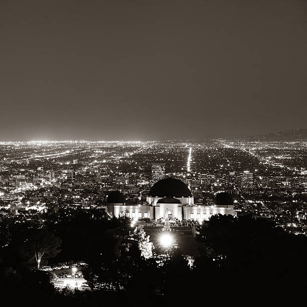 Los Angeles at night Los Angeles at night with urban buildings and Griffith Observatory griffith park observatory stock pictures, royalty-free photos & images