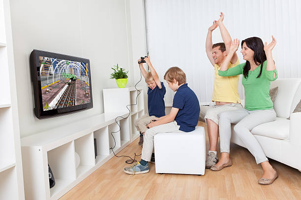 istock Young family playing video games 473442960