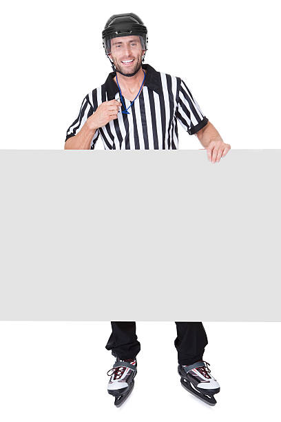 istock Portrait of hockey judge presenting empty banner 473443316