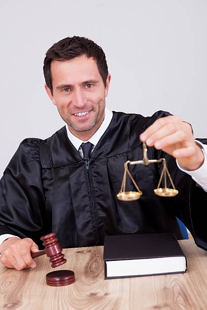 istock Male Judge Holding Scale 473443634