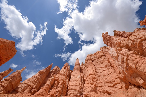 Colorful hoodoos, against bright blue sky and white clouds, at Queens Garden of Bryce Canyon National Park, Utah, USA.