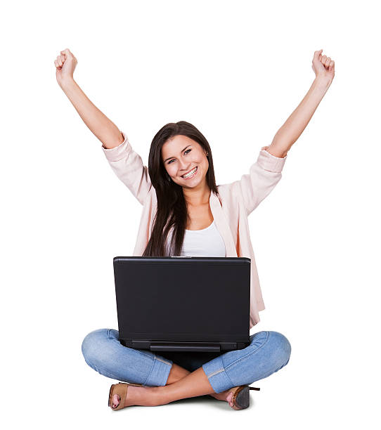 istock Woman sitting rejoicing with her laptop 473447868