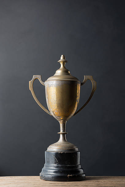 still life photography : old trophy on old wood with art dark background