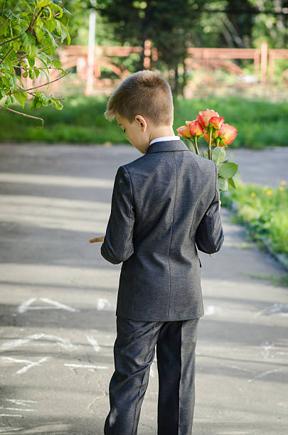 istock boy with a bouquet of flowers waiting 473448766