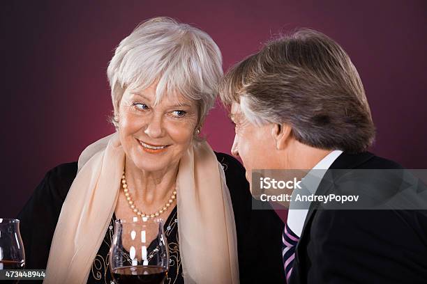 Senior Couple In A Restaurant Stock Photo - Download Image Now - 2015, Adult, Bag