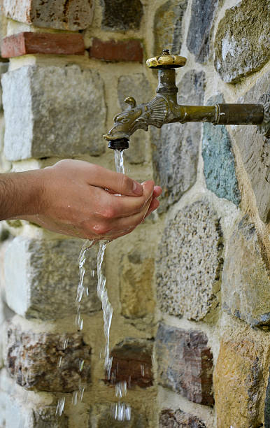 istock Washing hands under a running tap, outdoor 473451992