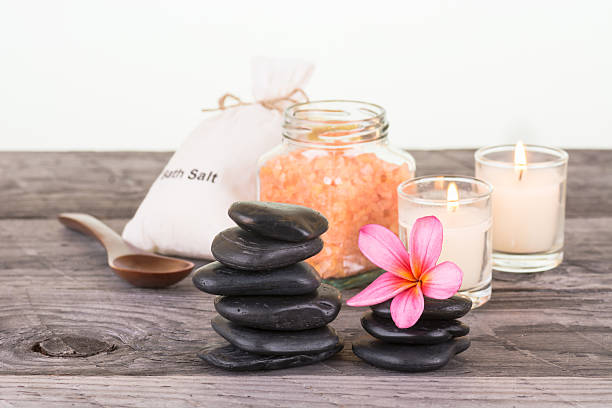 istock Spa setting with flower, bath salt and zen stones 473452962