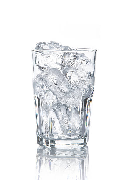 istock glass with ice cubes on white background 473454714
