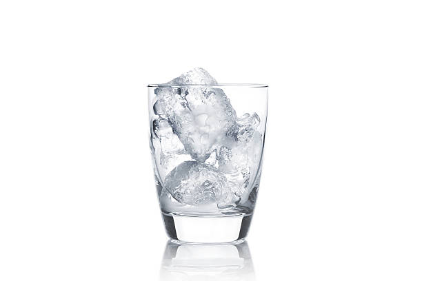 istock glass with ice cubes on white background 473454716